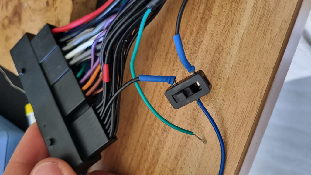 The modified adapter harness with the switch soldered on one of the splices